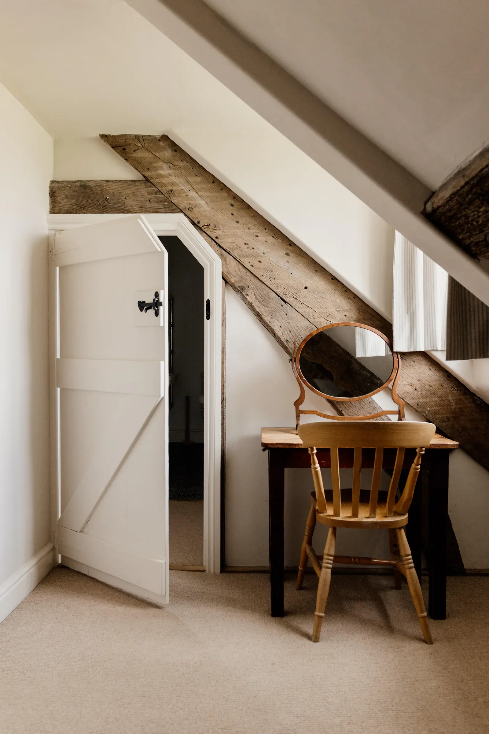 Landing with a plank door and an exposed oak post and brace