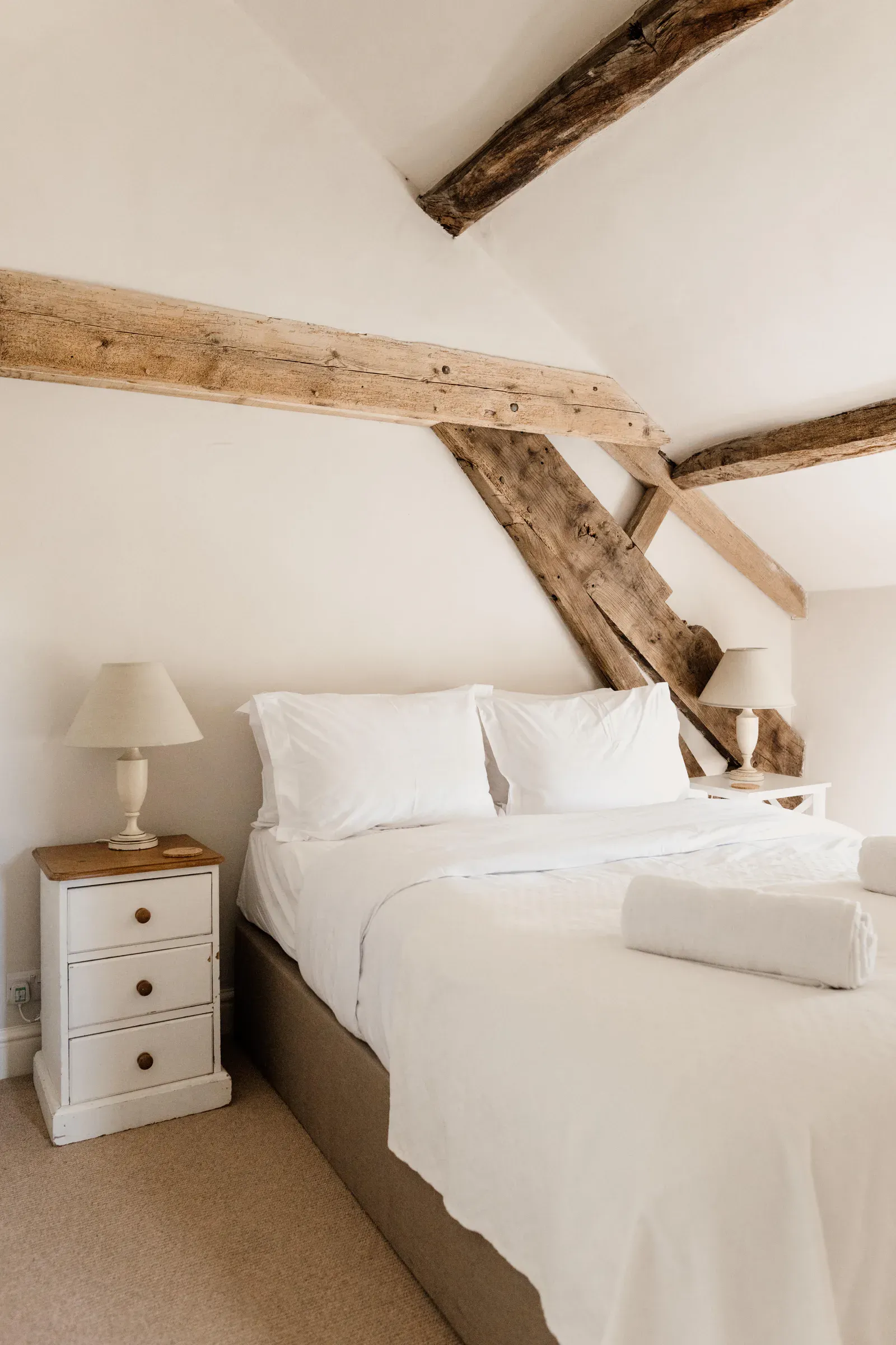 Bedroom under the new roof, with oak trusses left exposed