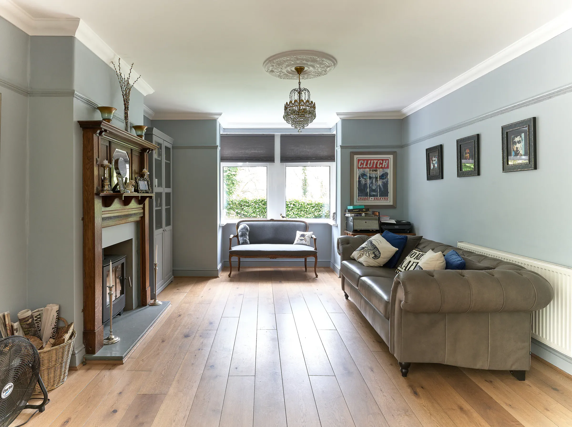 Sitting room with a period fireplace, engineered oak floor and a view through to the new kitchen