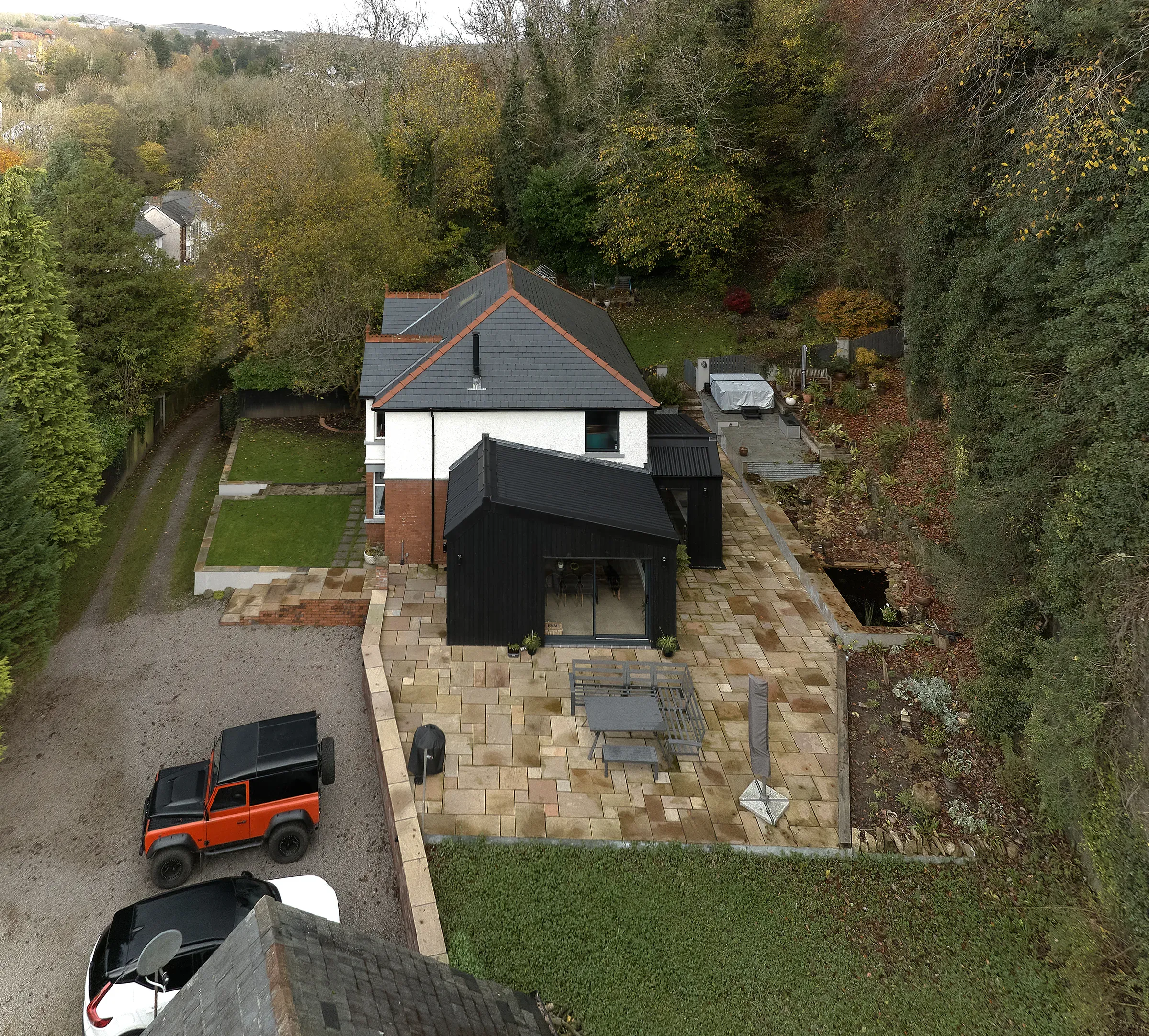 Aerial view of the house in its wooded valley setting above Pontypool
