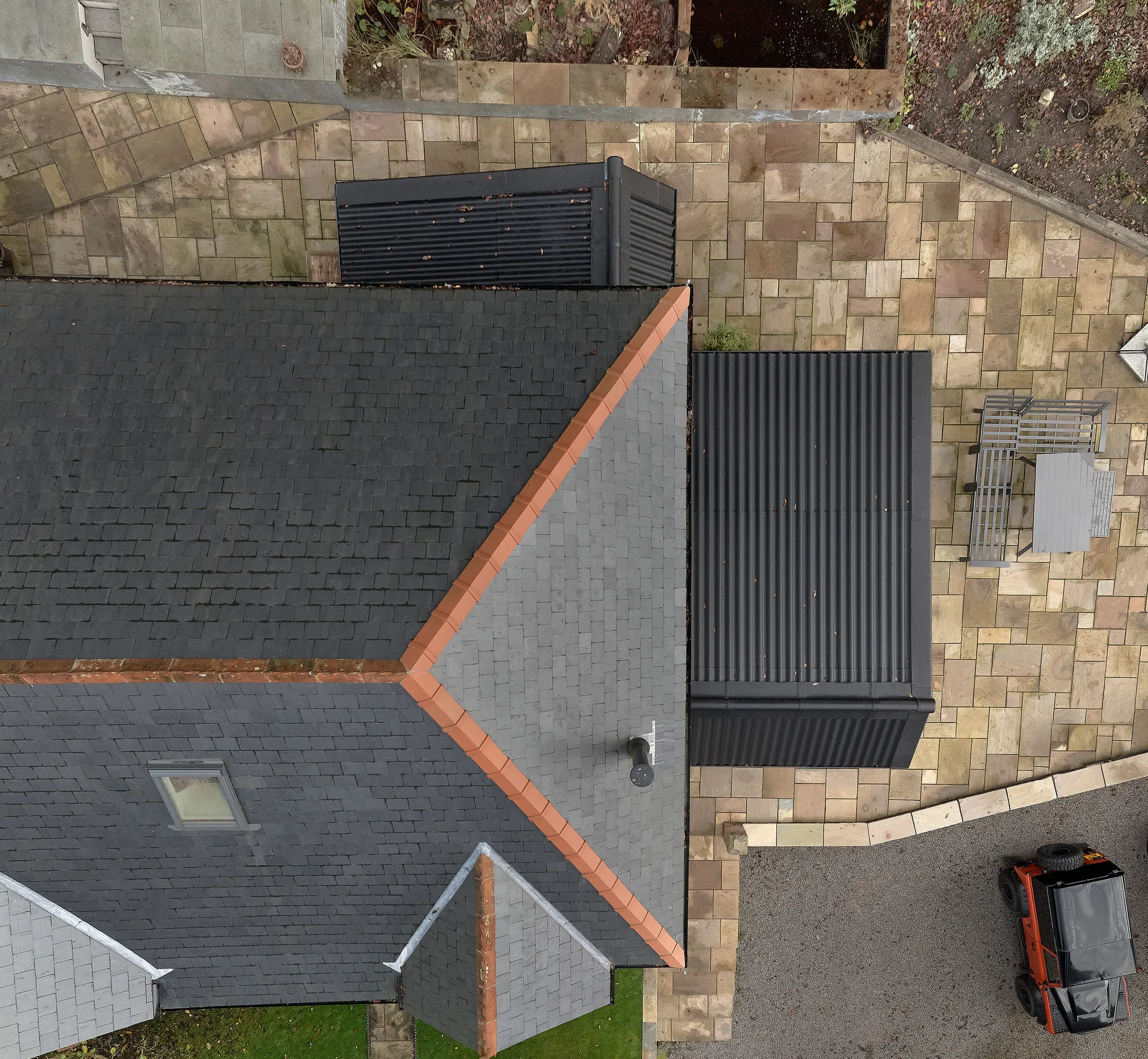 Aerial view straight down onto the roofs, showing the three new extensions around the original house