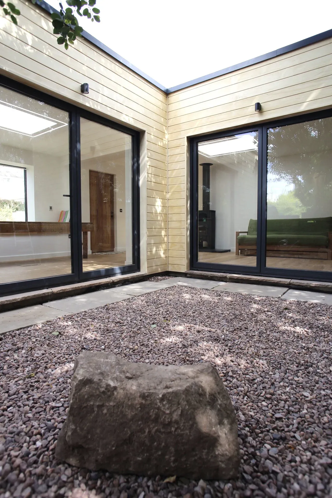 Gravel courtyard between the two glazed wings of the garden room