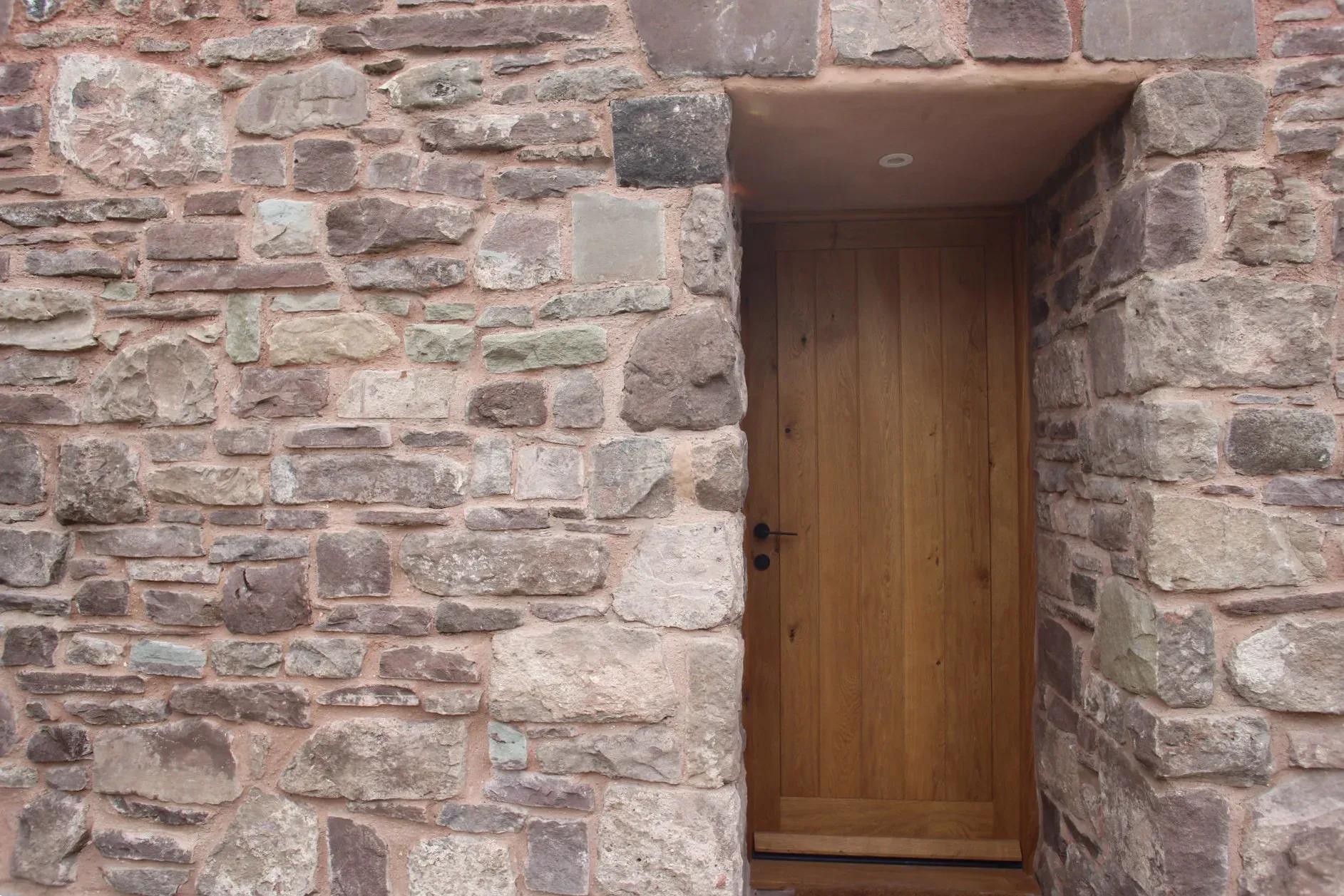 Detail of the stone façade and oak front door