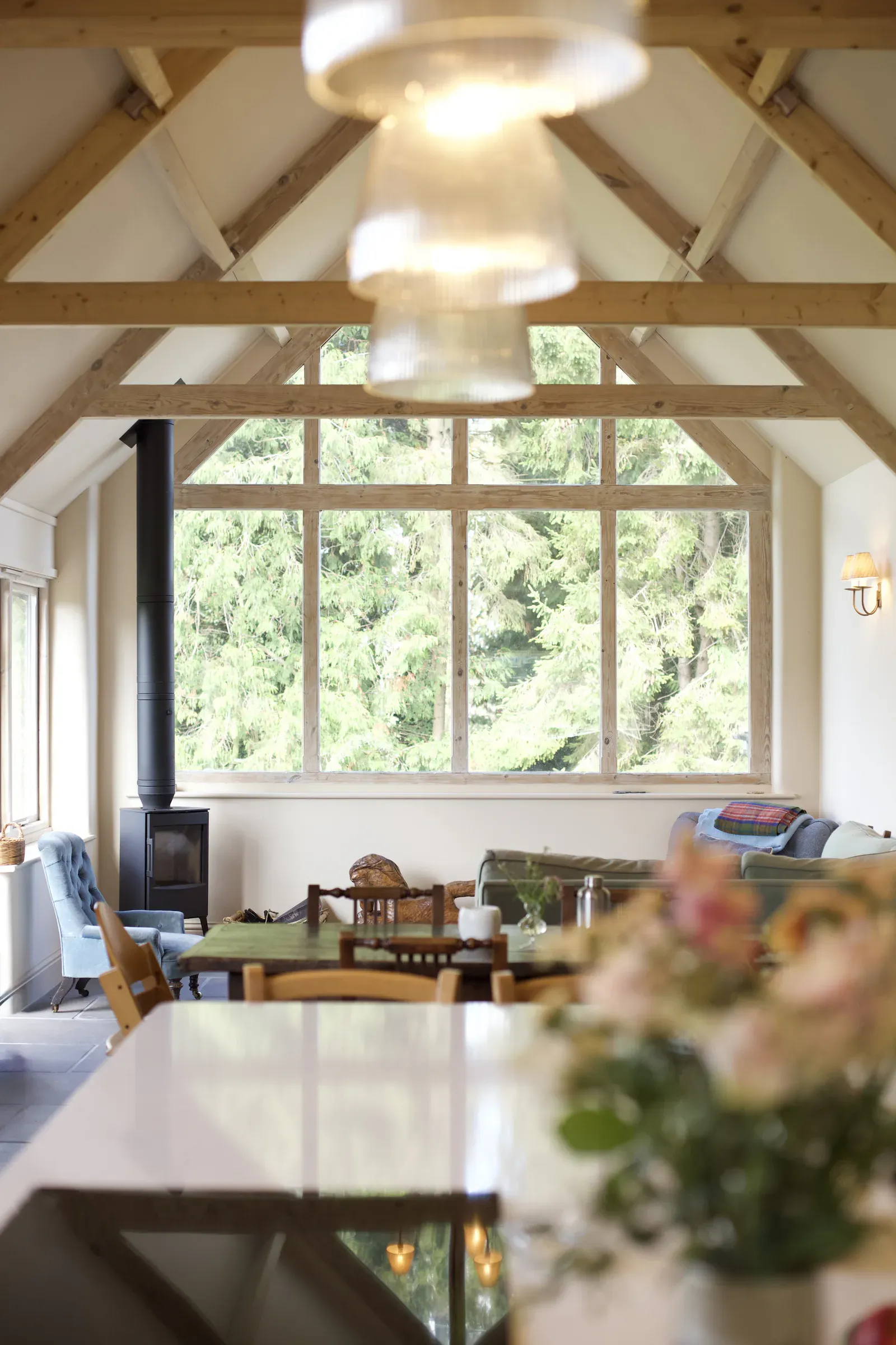 Dining table under the vaulted ceiling, looking out through the glazed gable
